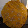 A large yellow sun with glittery white and silver flower patterns