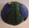 green with navy blue oceans. there is more green than blue. there are spme gold sequins dotted near blue areas