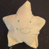 pale yellow star with a grinning moustached face
