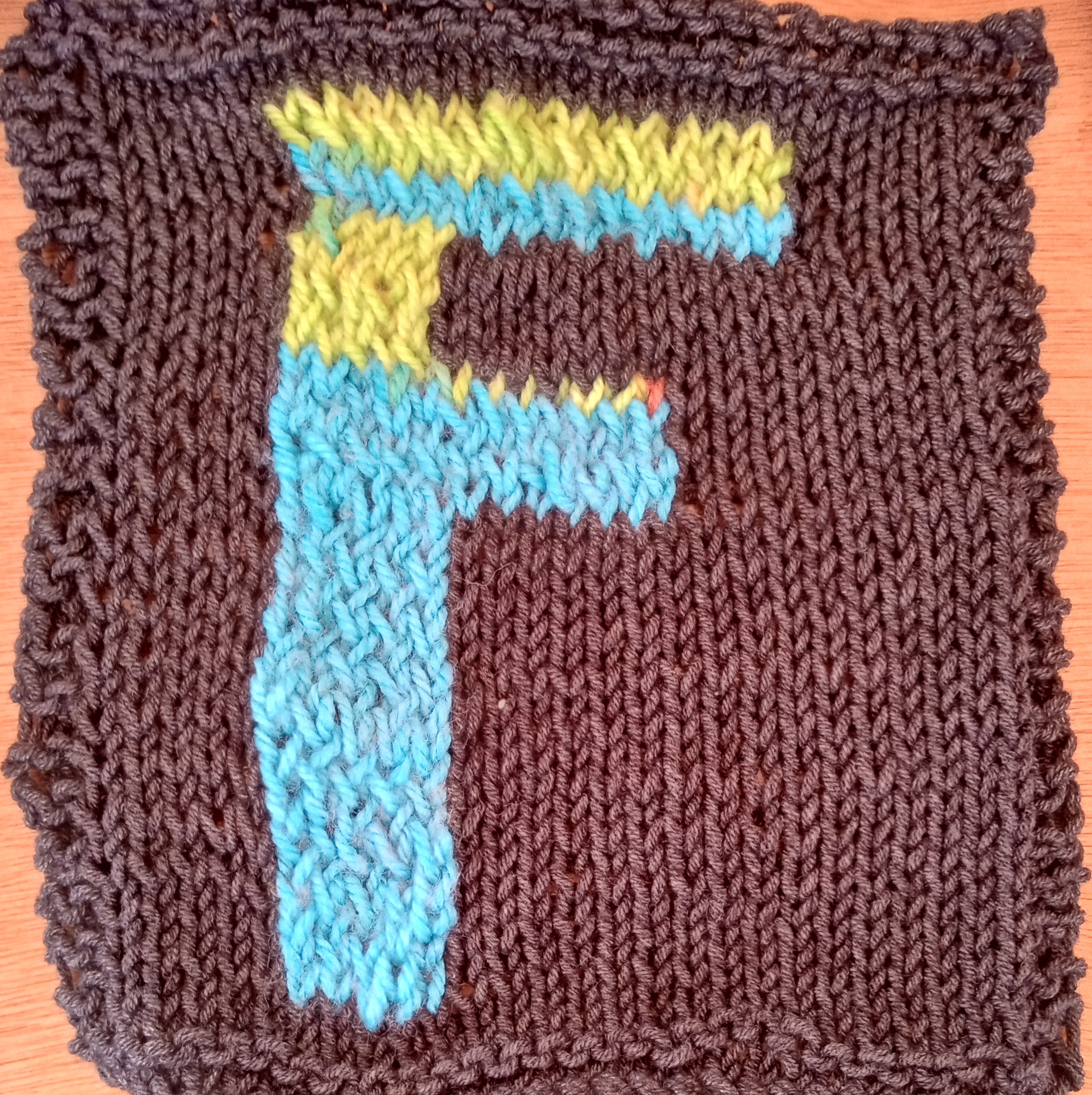 Grey square with blue and green letter F