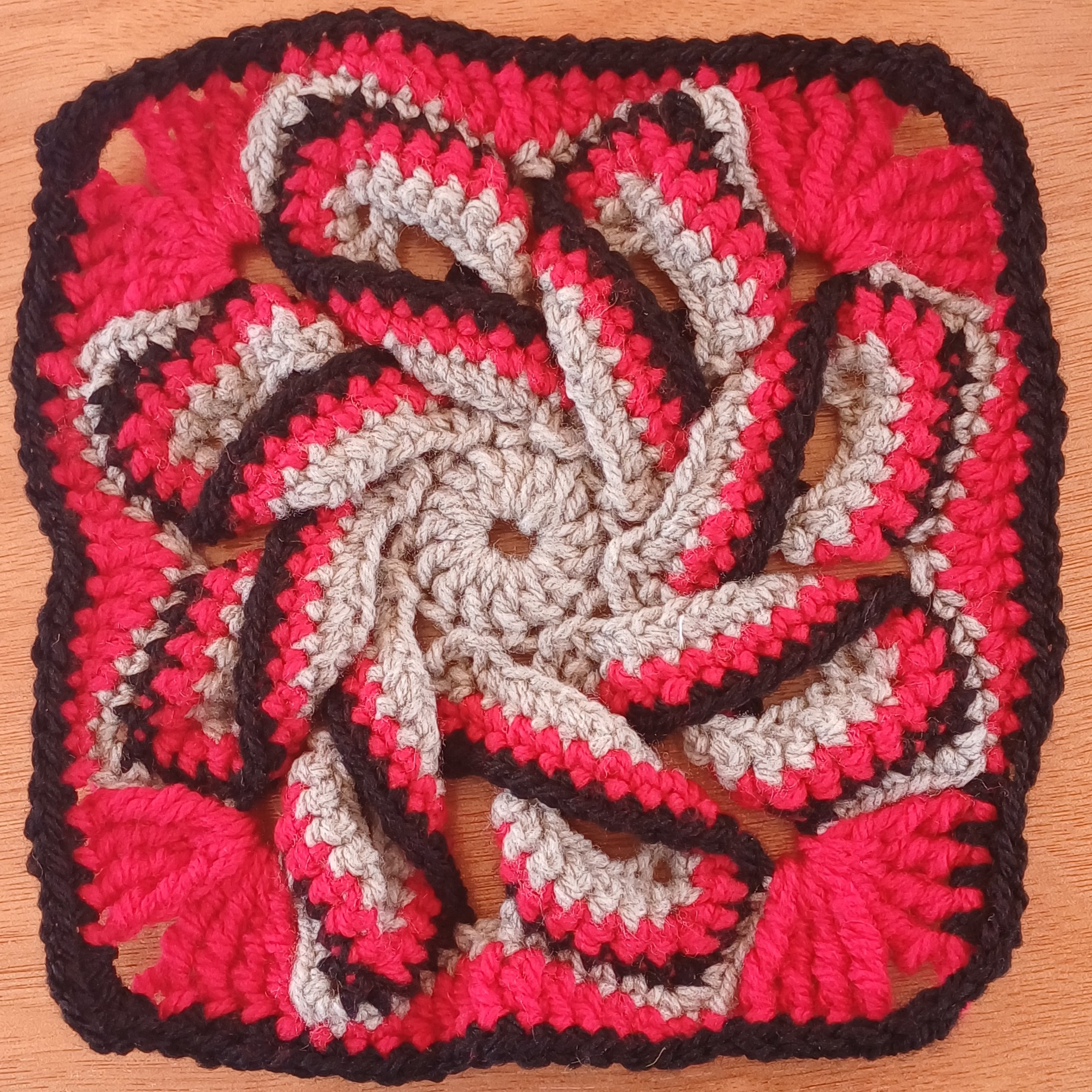 Grey, red and black spiral flower