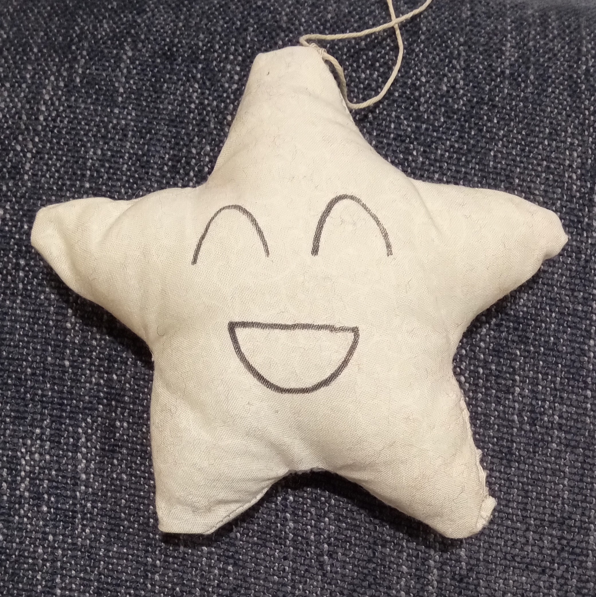 A five pointed white star with a grinning face on it