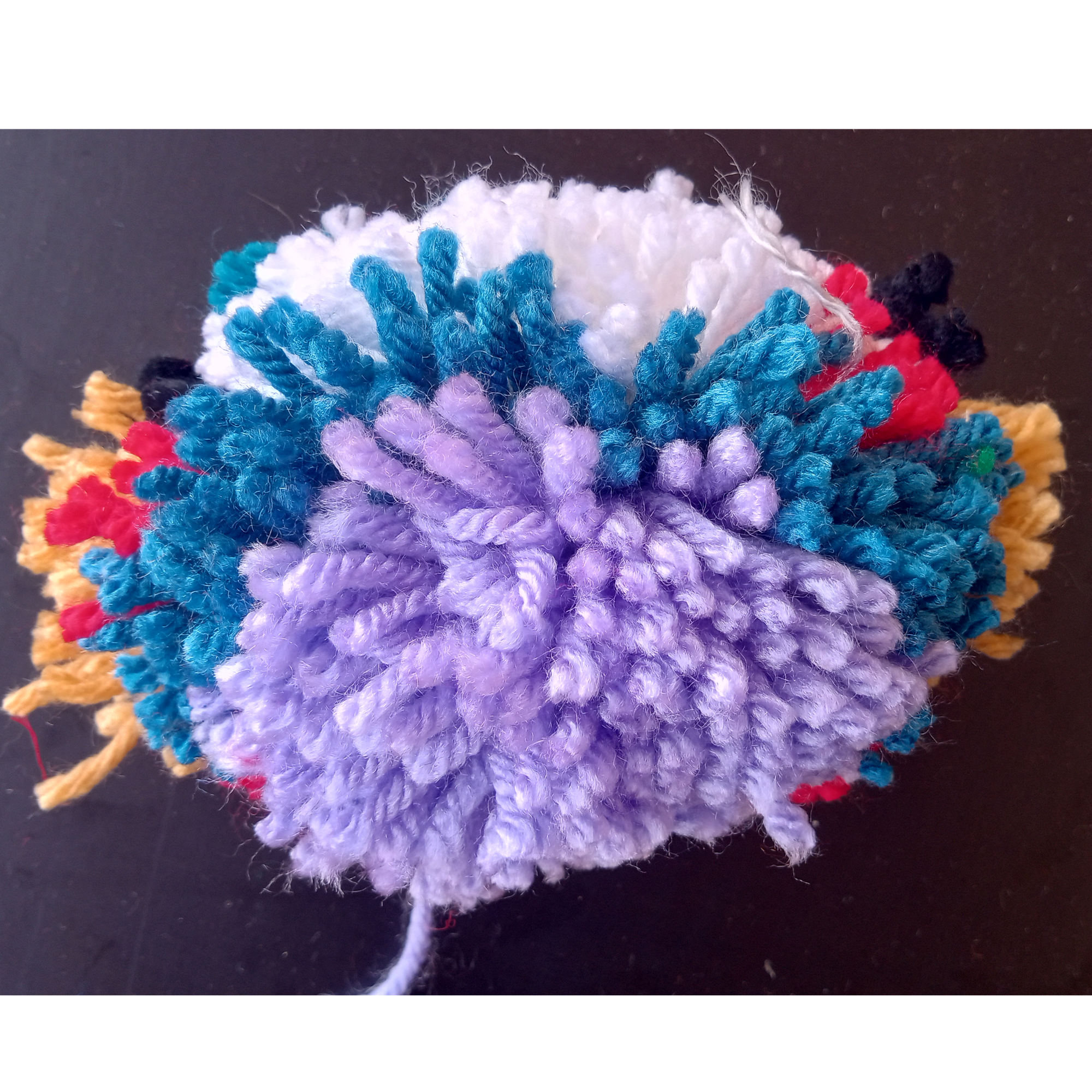 Oval planet with purple, blue, white, red, black, and tan splotches