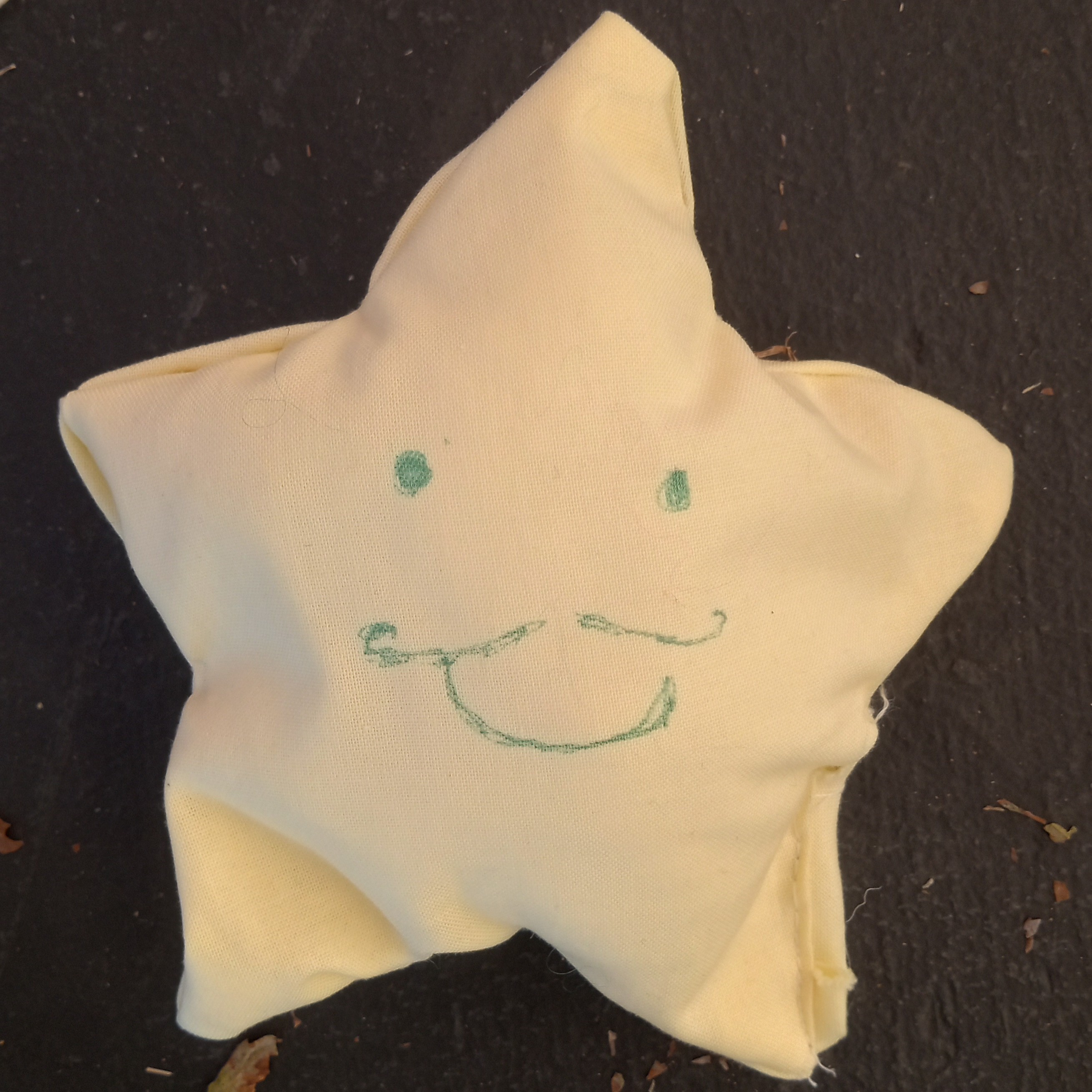 pale yellow star with a grinning moustached face
